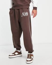 ASOS DESIGN ASOS Actual relaxed trackies with piping detail in brown (part of a set)