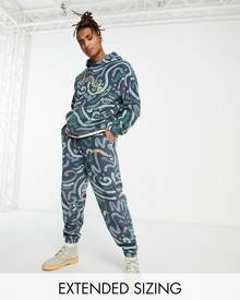 ASOS DESIGN ASOS Daysocial relaxed trackies in polar fleece with all over doodle print in navy (part of a set)