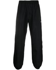 Danton logo-patch tapered-leg trousers - Black