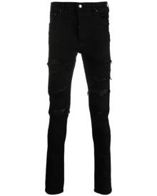 AMIRI logo-patch cotton-blend skinny jeans