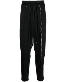 Mastermind World camouflage-print track pants - Black