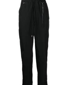 Mastermind World logo-print tapered-leg trousers - Black