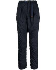 Undercover logo-tag buckle-fastening tapered trousers - Blue